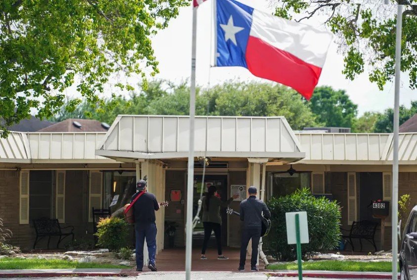 Members of a church group sang and prayed in front of San Antonio's Southeast Nursing and Rehabilitation Center in April. On Friday, the the Texas Department of State Health Services added residents of long-term care facilities to the first tier of people who would be eligible for a coronavirus vaccine.